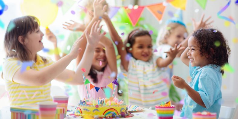Children celebrating with cake, confetti, and decorations, offering fun birthday party ideas for kids.