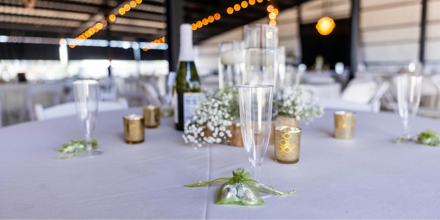 Minimalist wedding reception decor with candles, champagne flutes, and ambient lighting