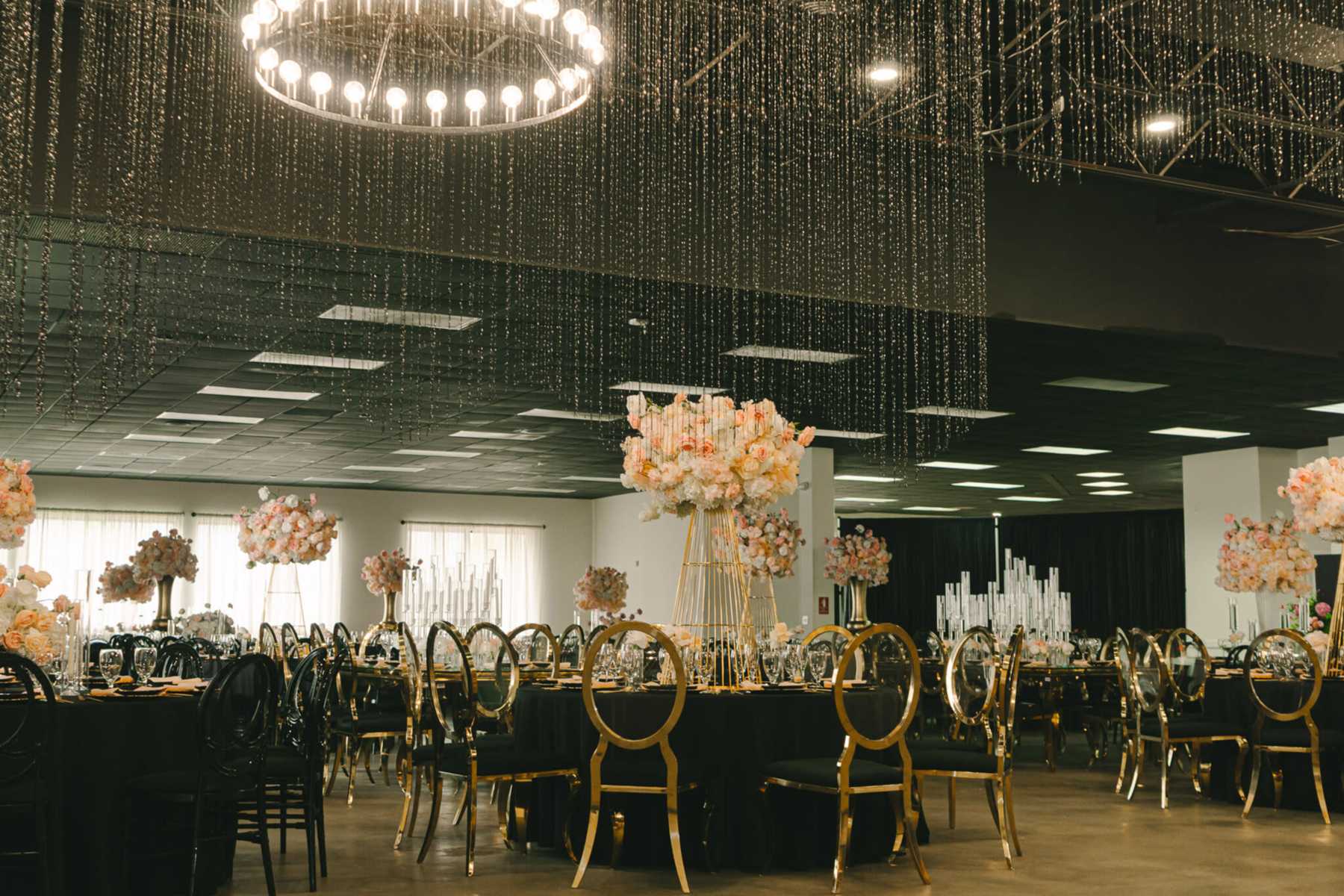 Luxury ballroom wedding reception setup with grand floral chandeliers in Miami