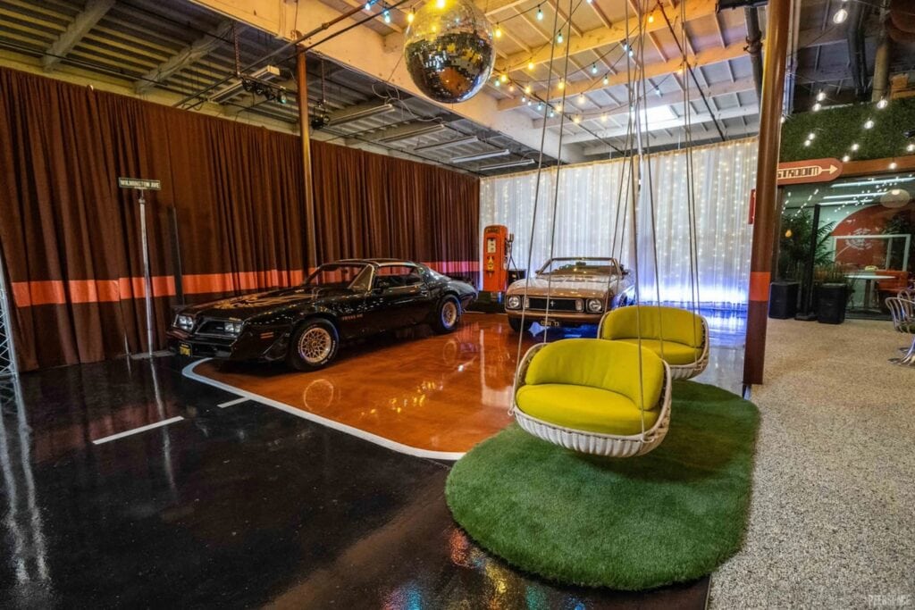Vintage cars are on display in a disco-vibe party space