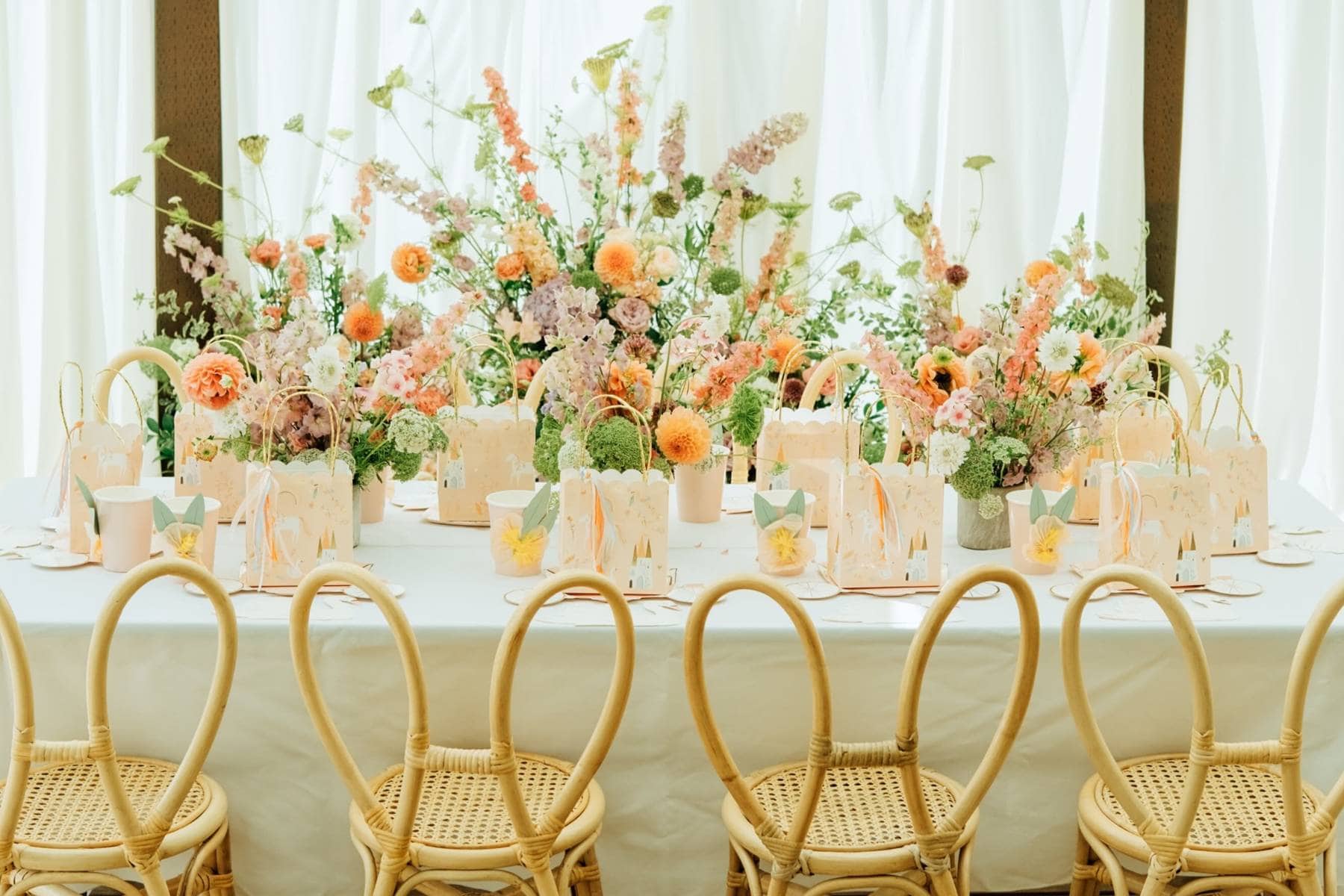 Chic tropical modern wedding reception table with wicker chairs in Miami