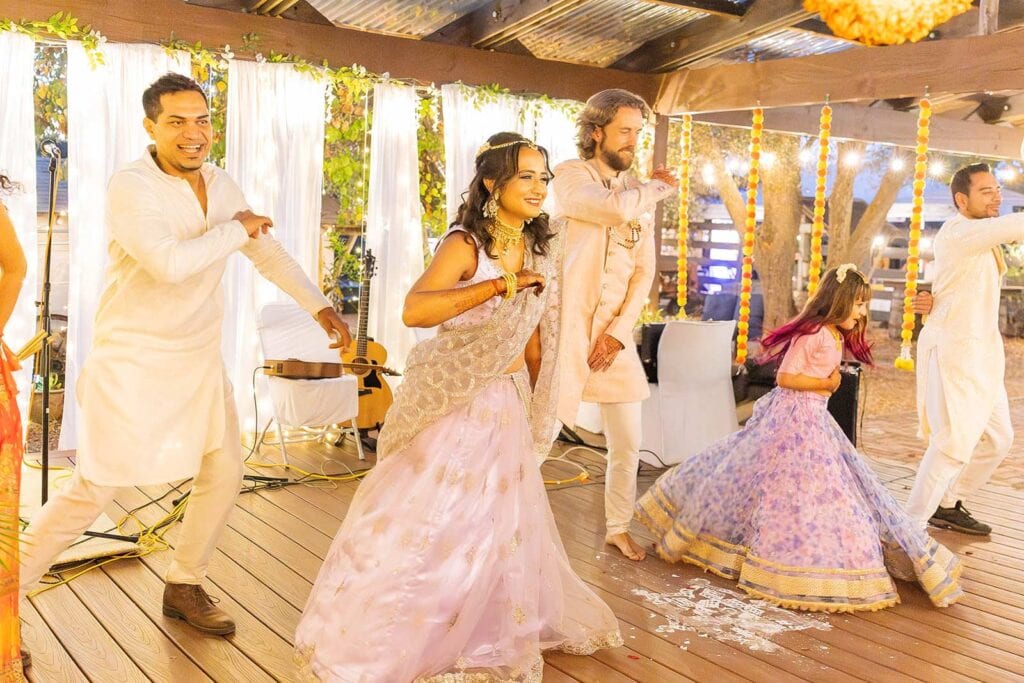 Vibrant outdoor multicultural wedding celebration with dancing guests in Philadelphia