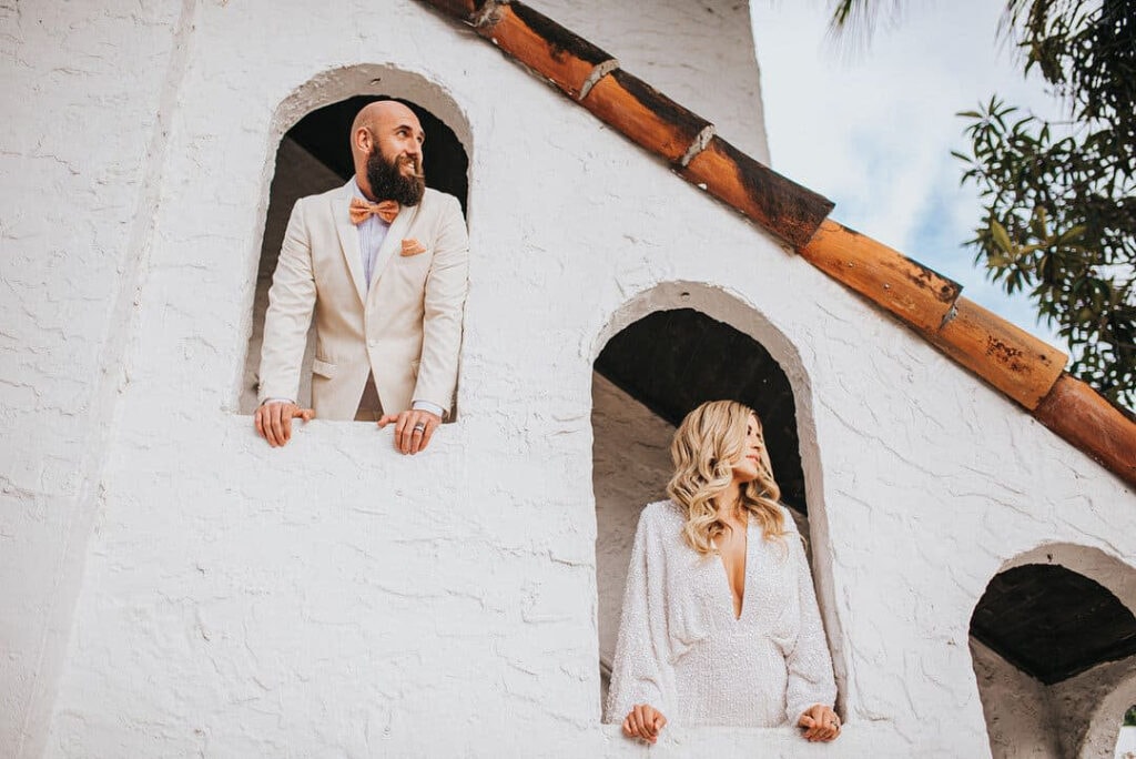 Stylish couple posing in arched doorways for San Francisco wedding engagement shoot
