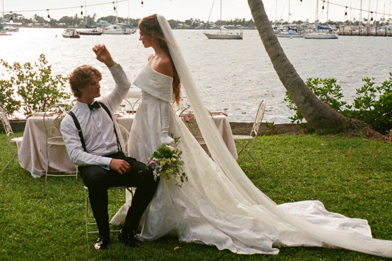 Bride and groom posing by harbor for Florida wedding planners portfolio