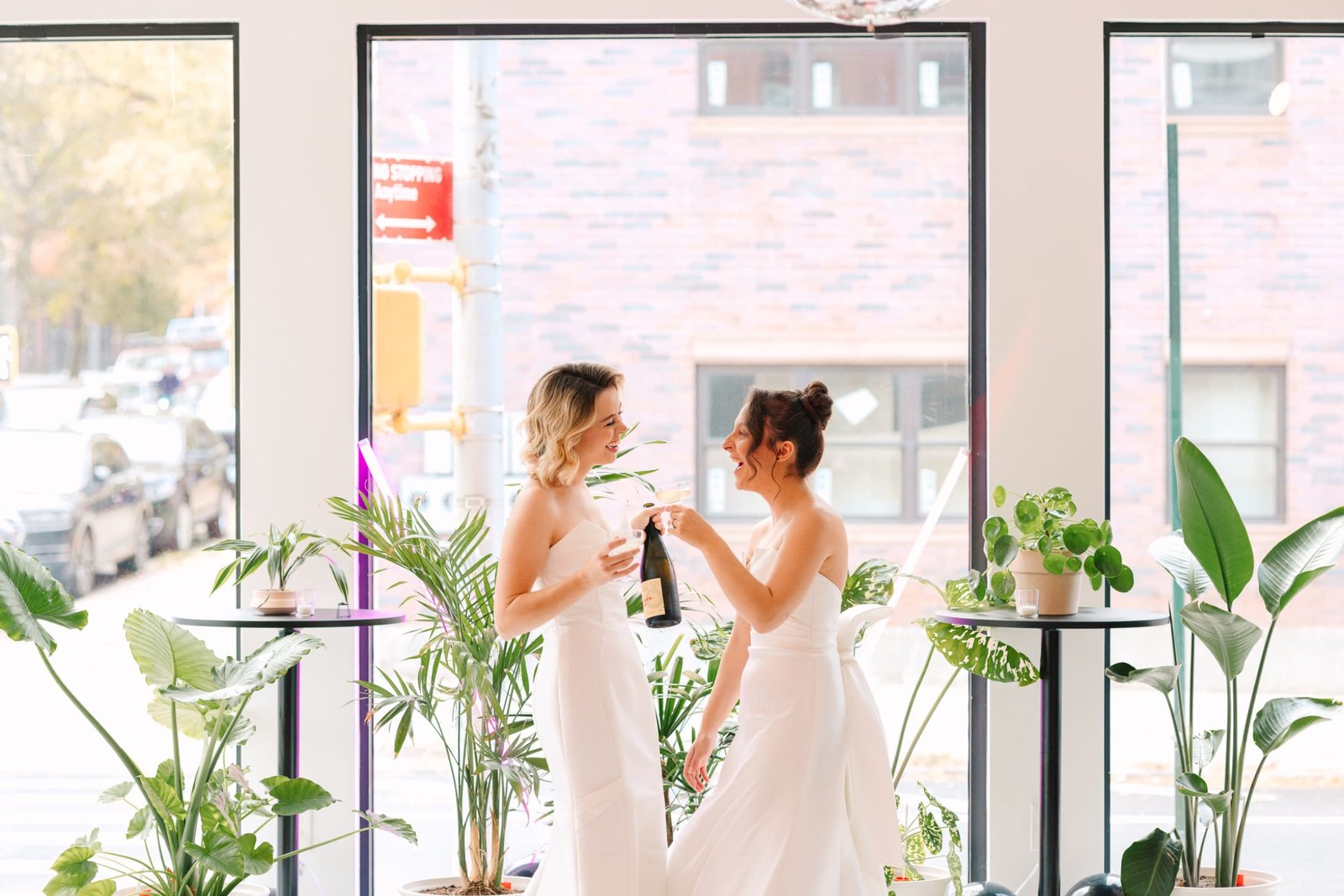 Two brides celebrating wedding day in bright Boston event space