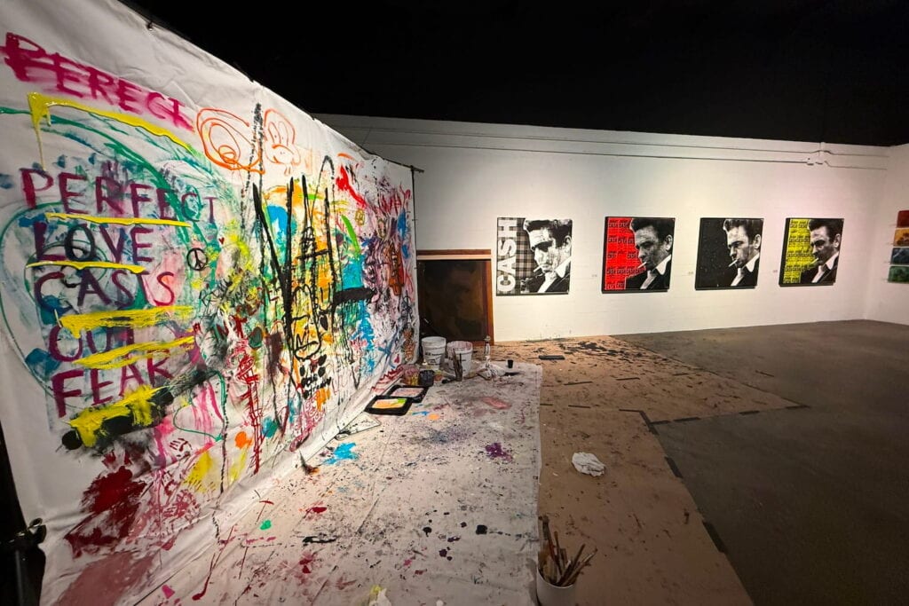 Graffiti art painted on a drop cloth hangs on a wall at a Nashville, TN gallery