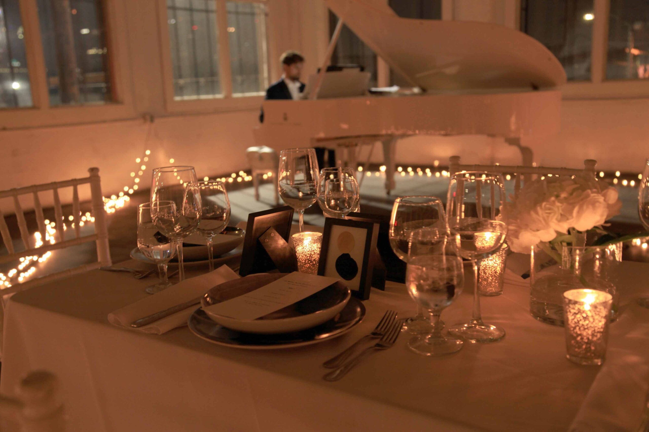 Candlelit dining table setting overlooking the city skyline at a Las Vegas event venue