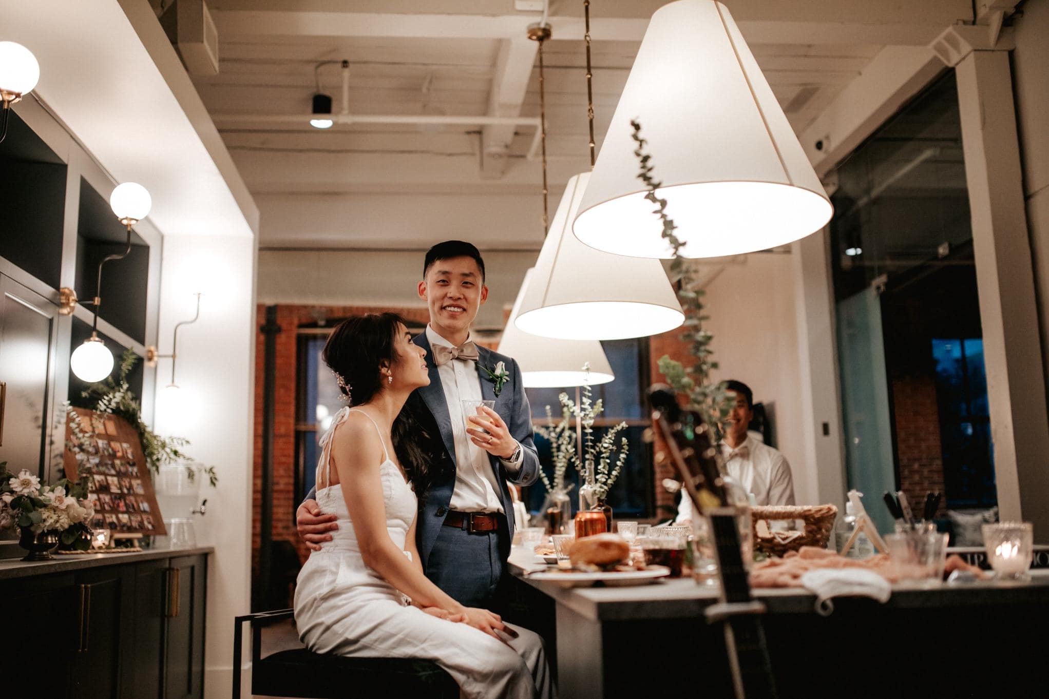 Happy couple dancing at rustic string lit Milwaukee wedding reception