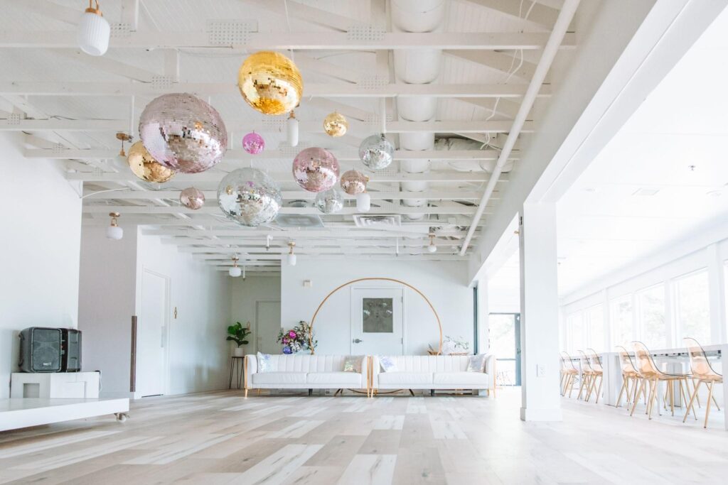 Open space with disco balls and white couches for Los Angeles party