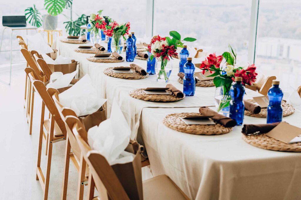Long reception table with blue bottles styled by San Francisco wedding planners