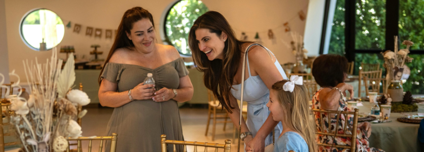 Gemini said This photograph captures a warm, candid moment during an event setup or social gathering, likely illustrating the "On-Site Execution" or "Manage the Event Team" phase of event management.