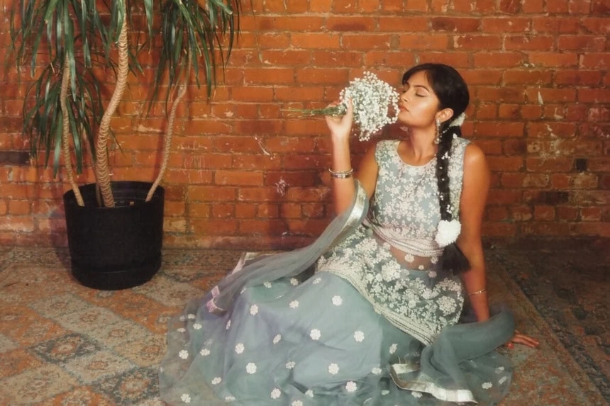 Bride posing with florals in indoor wedding venue for Indiana