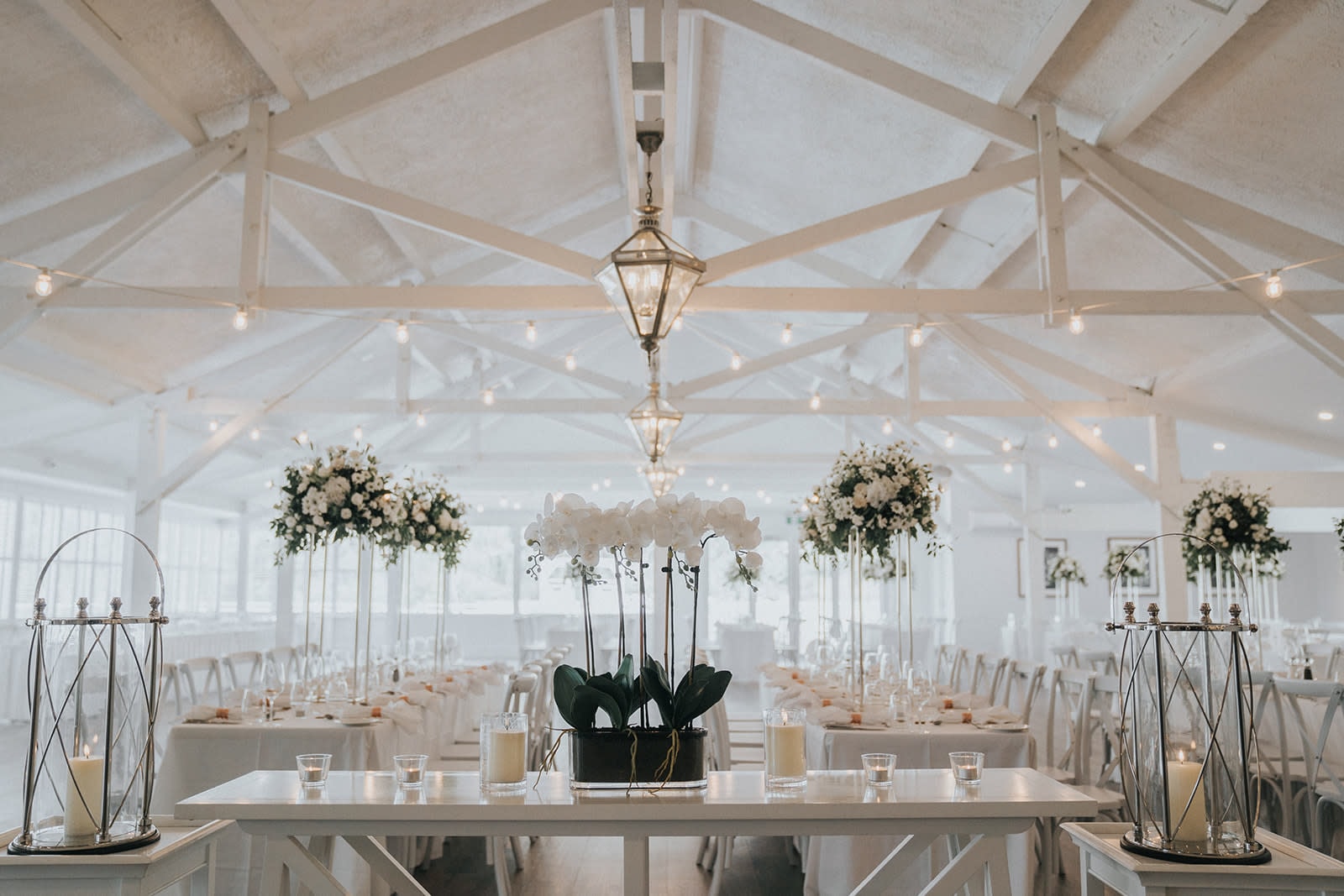 Elegant Maine wedding reception venue with vaulted ceilings and floral centerpieces