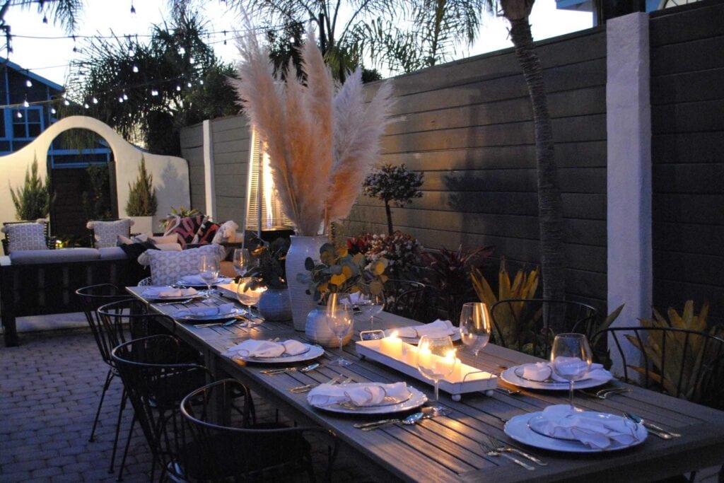 Nighttime dining outdoor Los Angeles party space with florals and plates