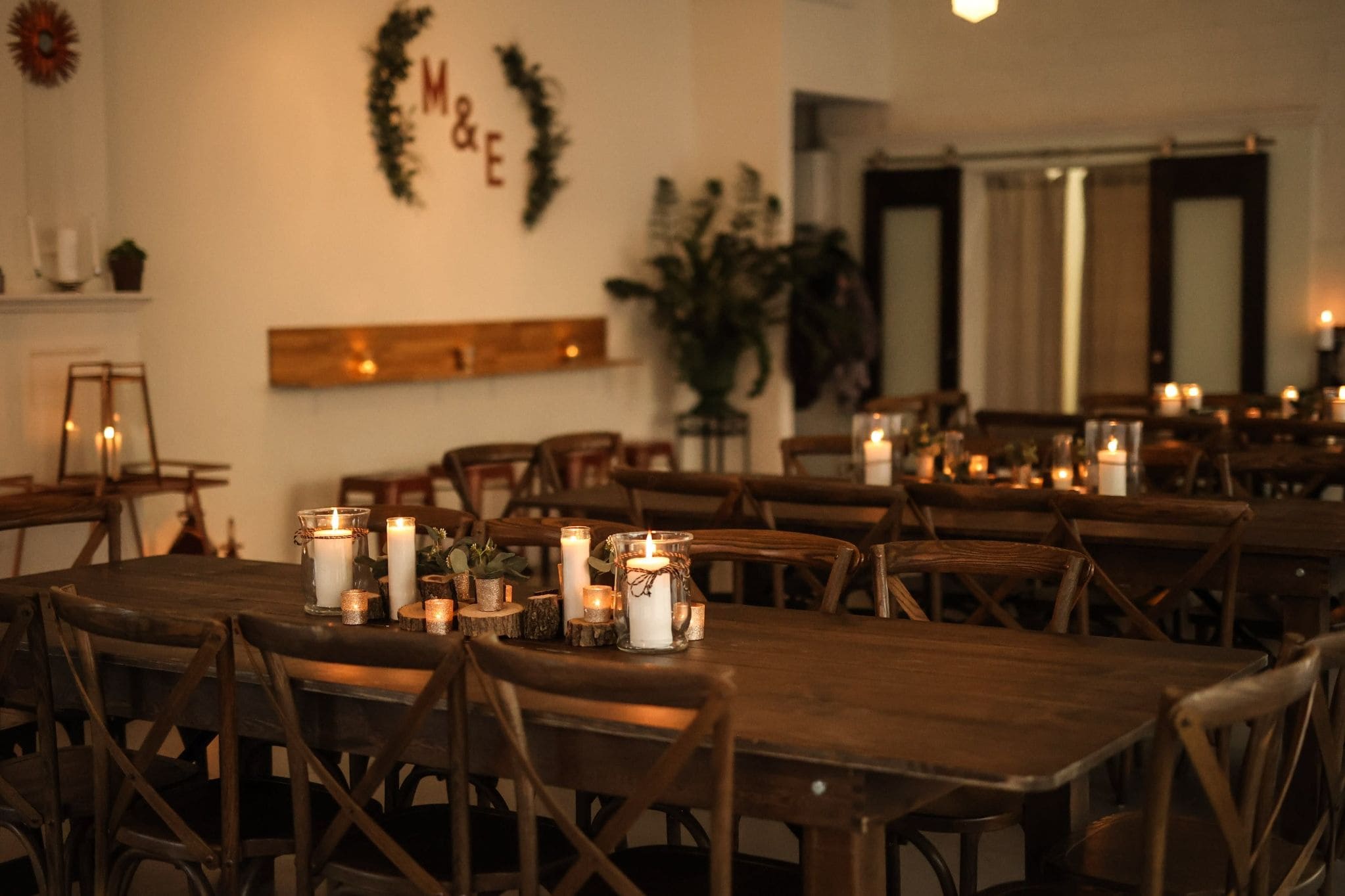 Intimate Pittsburgh wedding reception with warm candlelight and rustic wooden tables