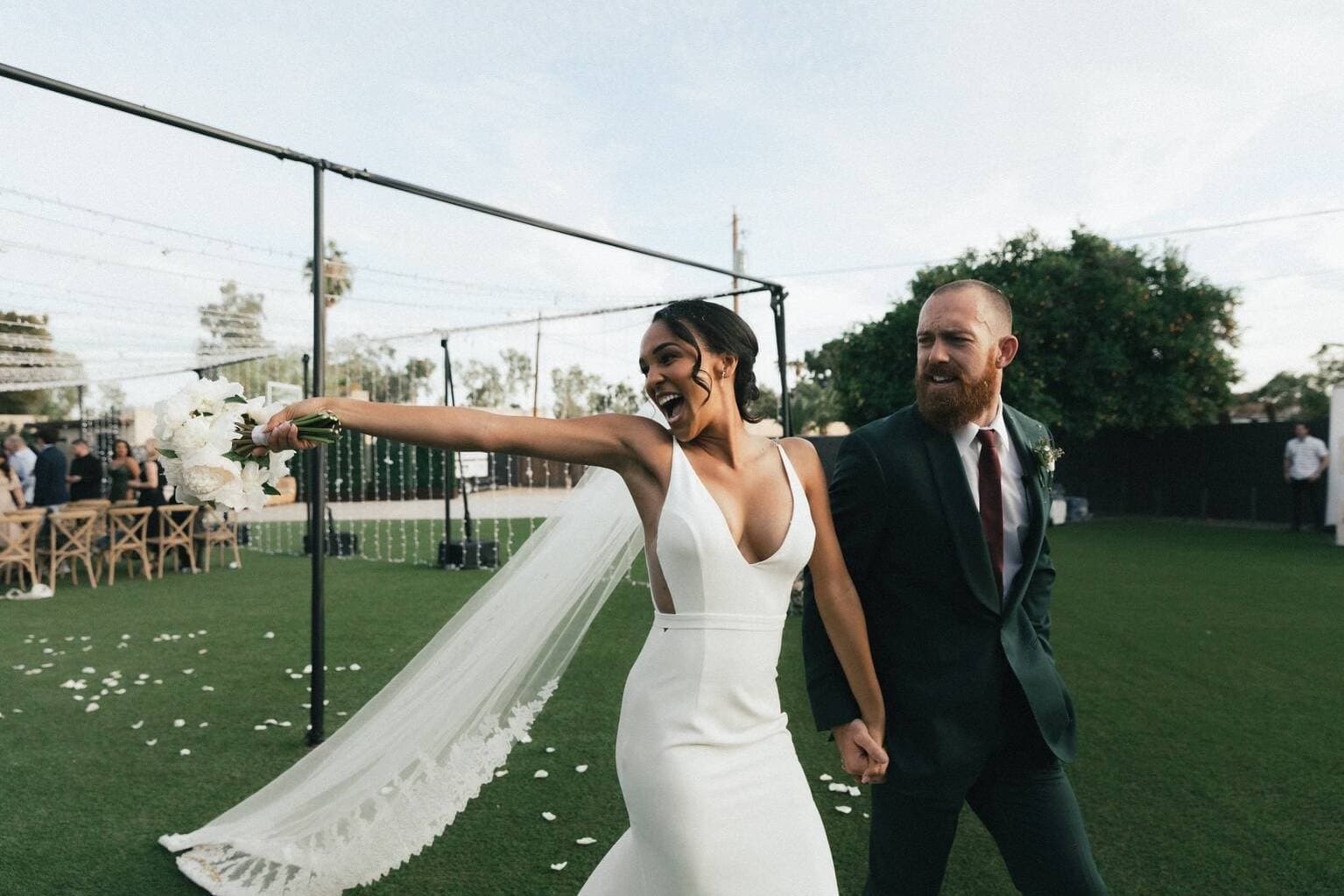 Happy couple celebrating outdoor wedding ceremony on Fort Worth lawn