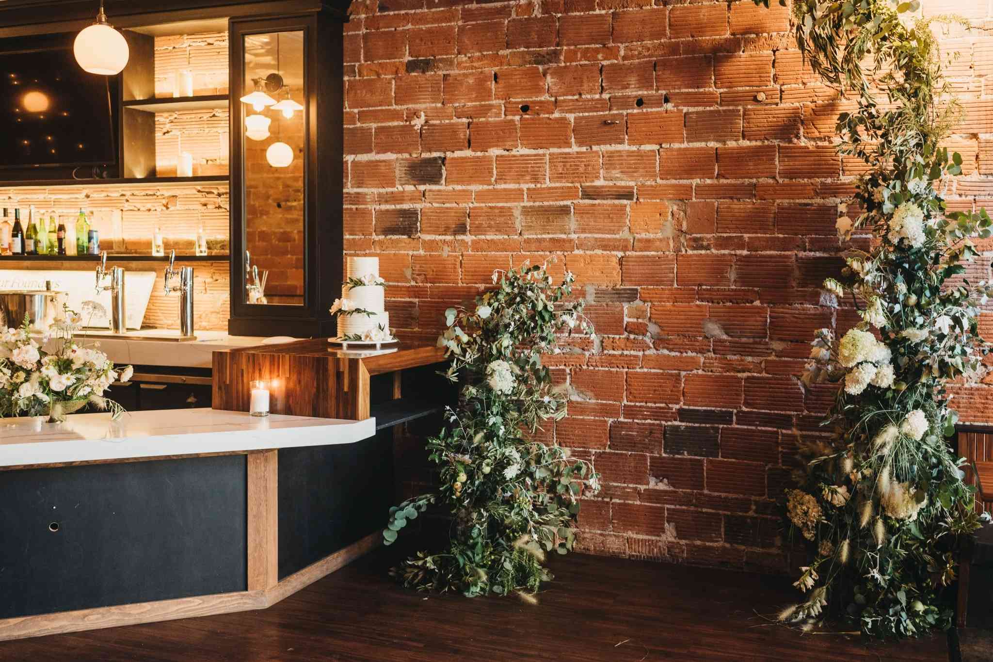 Elegant industrial wedding venue in Baltimore featuring exposed brick and florals