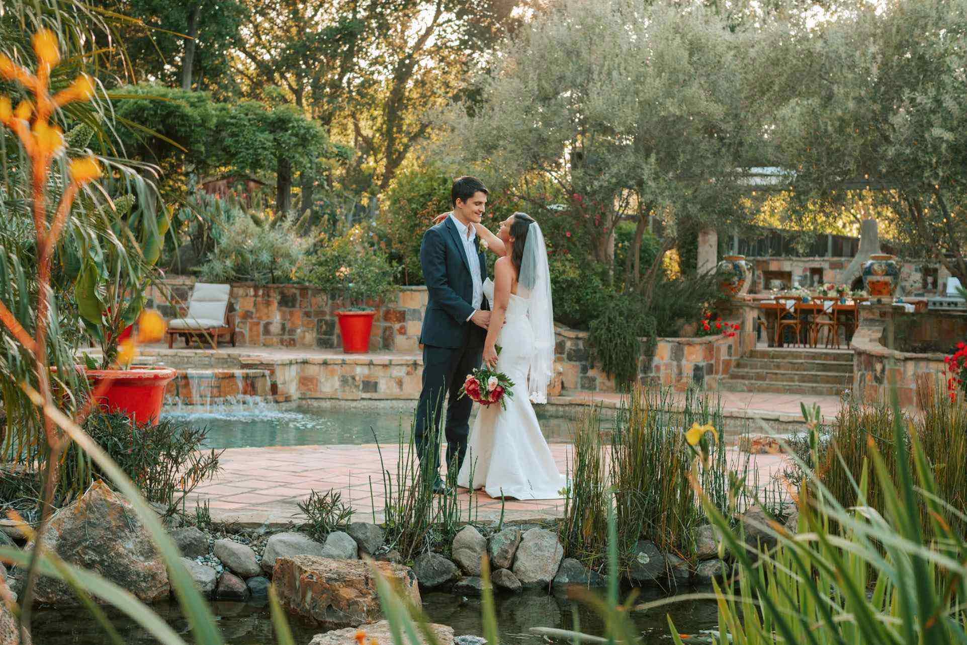 Bride and groom embracing in lush Memphis garden wedding venue