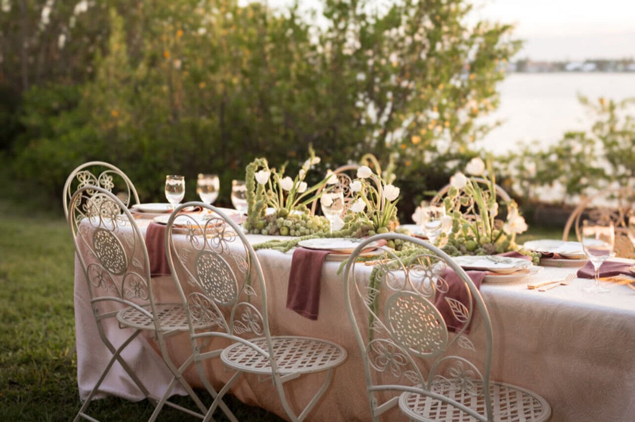 Elegant outdoor dining table setup with greenery for a Virginia Beach wedding