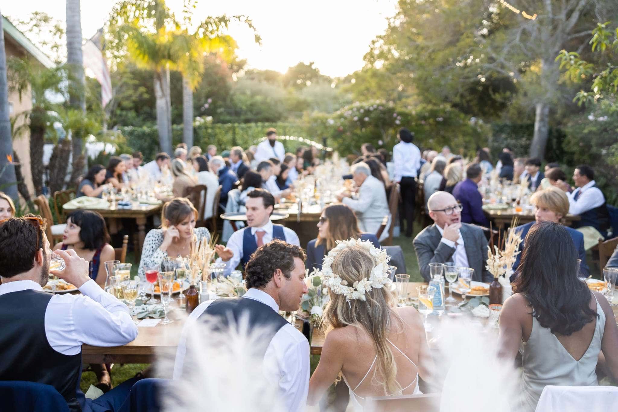 Joyful outdoor wedding reception dinner organized by Virginia Beach wedding planners