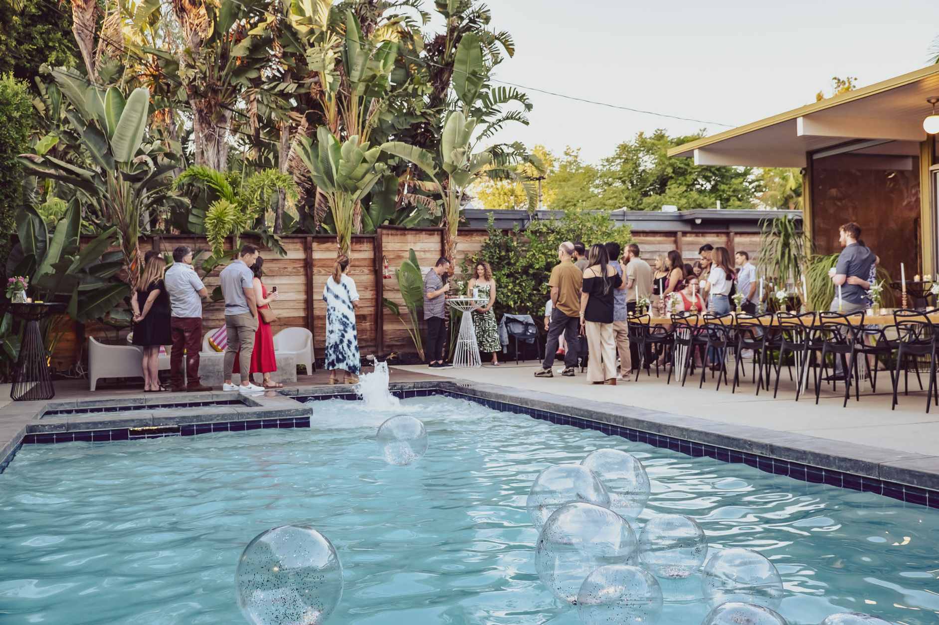Guests mingling at a vibrant outdoor pool party in a modern Miami home