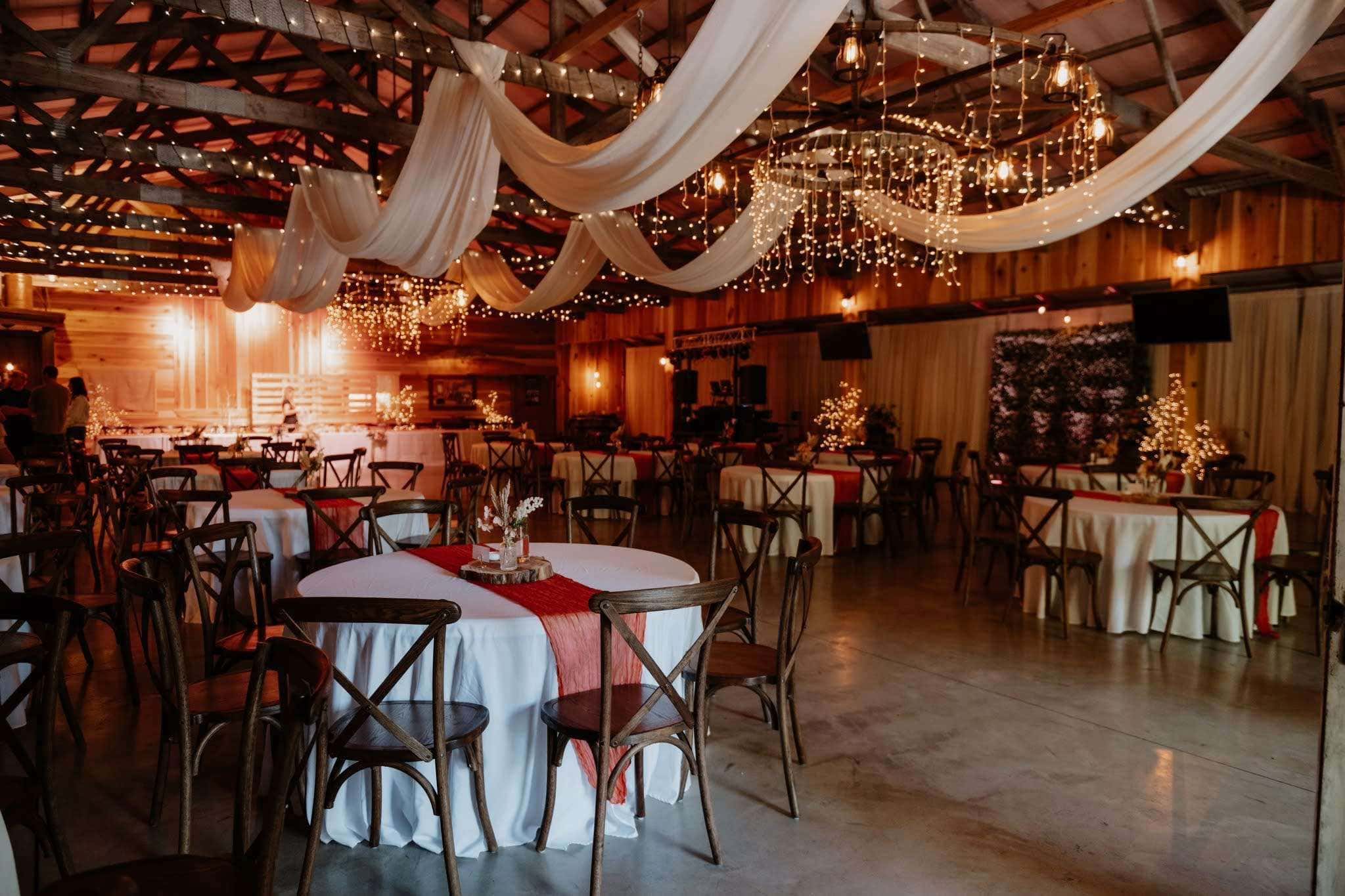 Rustic Memphis wedding reception venue with draped fabric and chandeliers