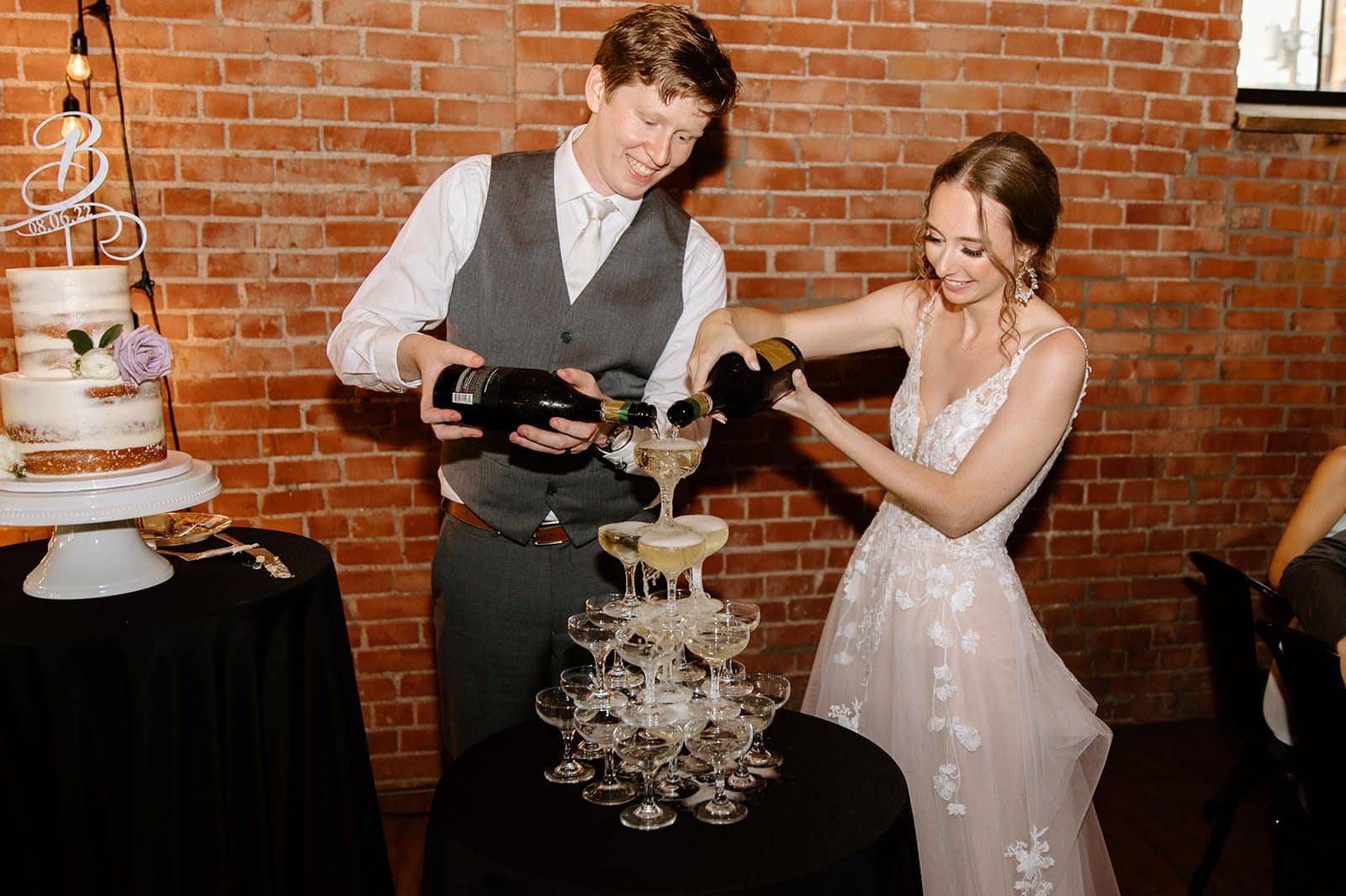Bride and groom pouring a champagne tower at a Pittsburgh wedding reception