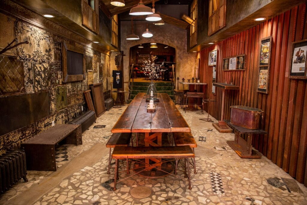 Dark wood and stone room with moody lighting and long reception table at a wedding venue in Pennsylvania