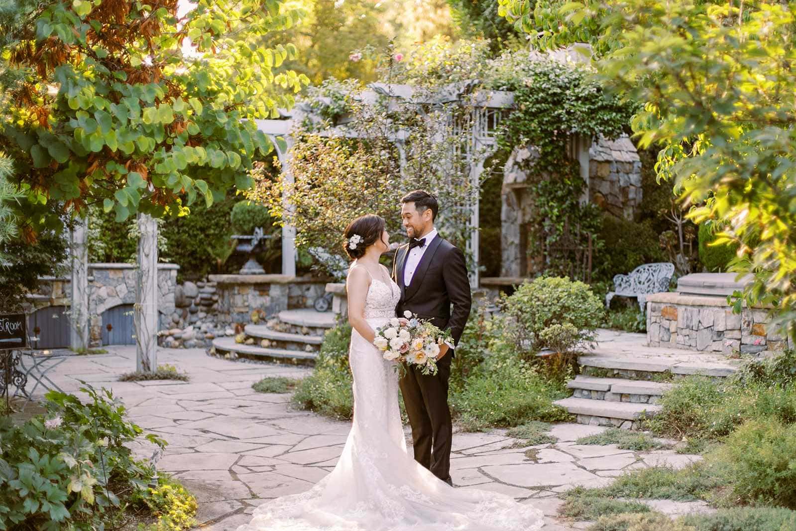 Bride and groom posing in lush South Carolina garden courtyard wedding venue