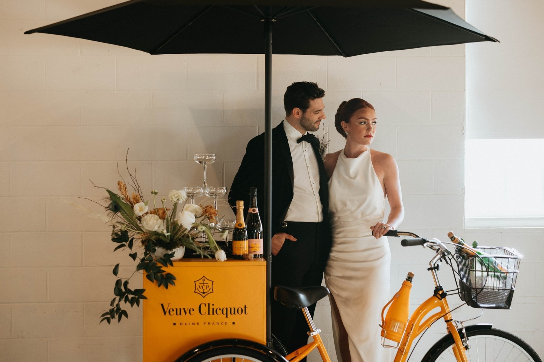 Stylish couple with champagne cart at modern New Hampshire wedding reception