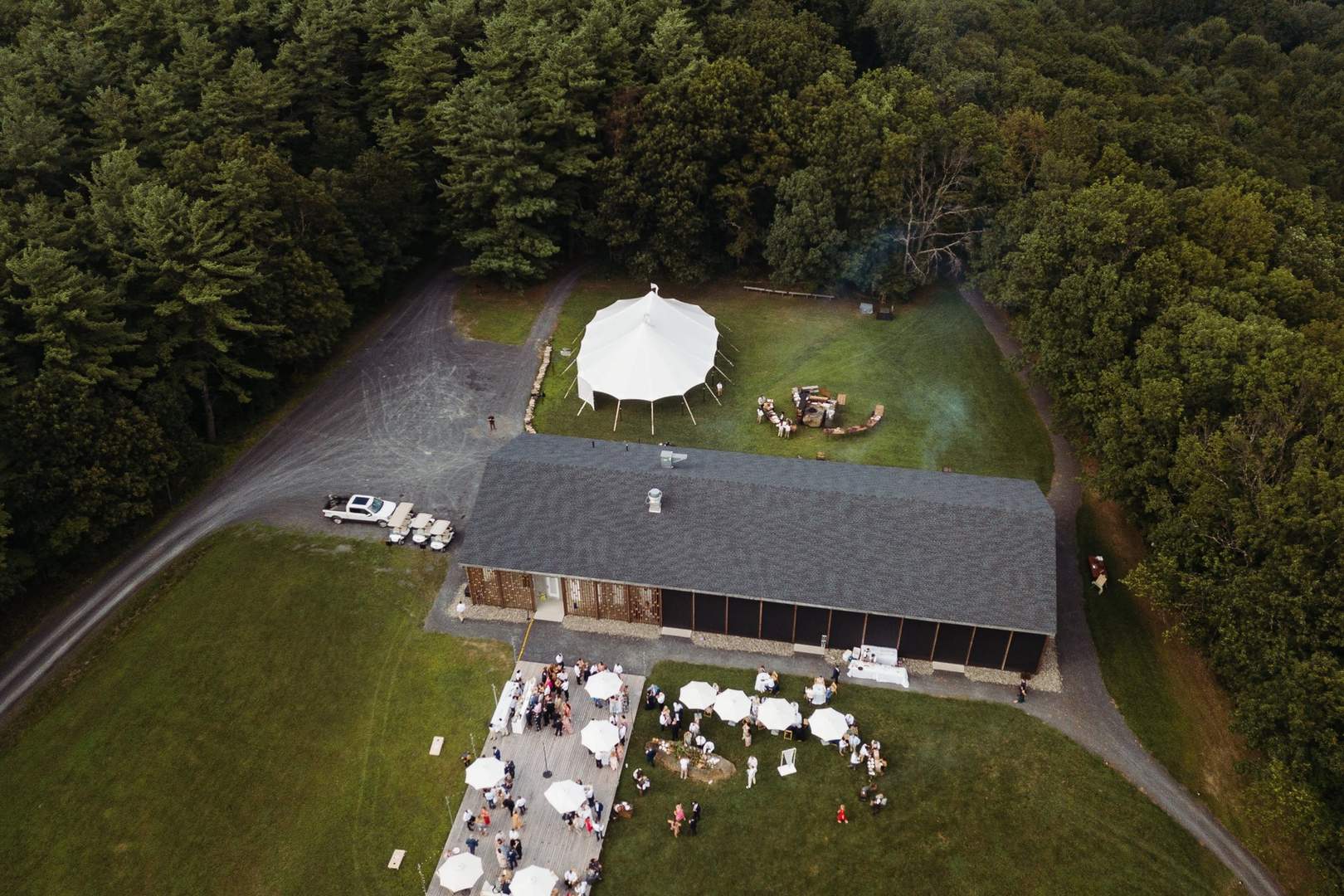 Aerial view of outdoor wedding venue with tent in New Hampshire forest