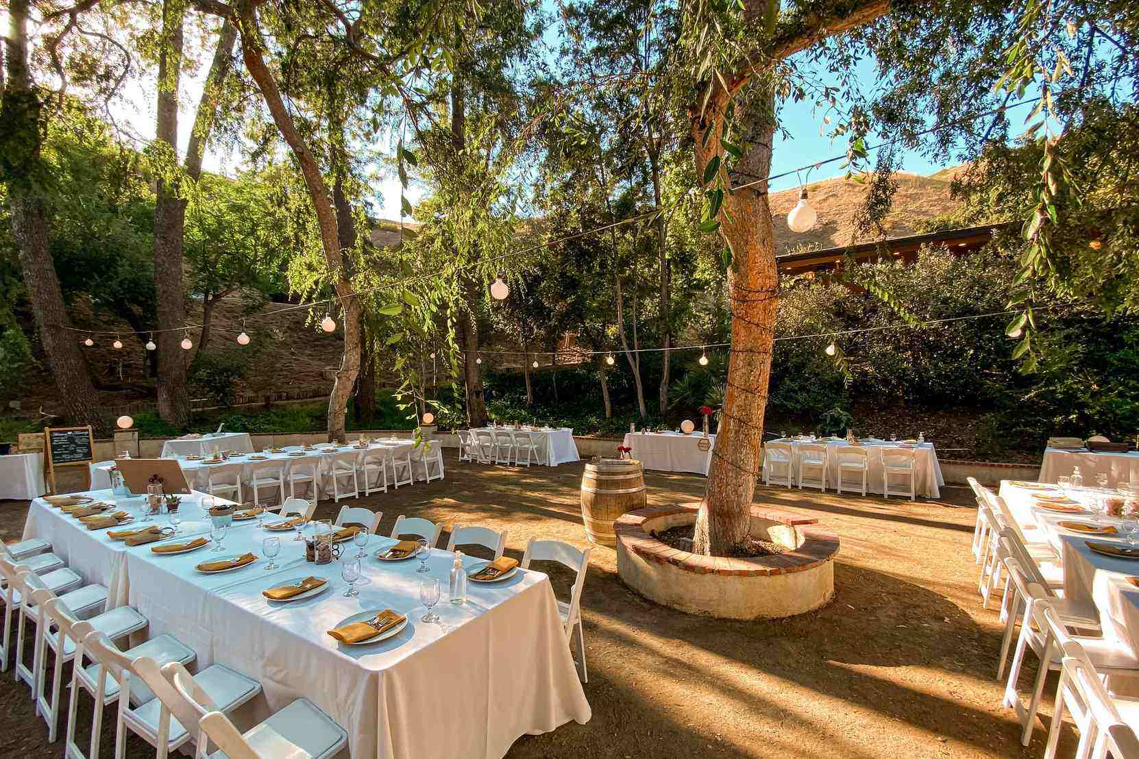 Decorated outdoor Fresno wedding venue with string lights and tables