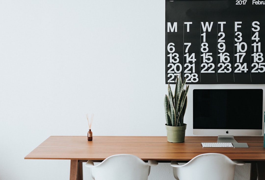A beautifully arranged desk centerpiece featuring flowers, candles, and decorative items that enhance the workspace ambiance.