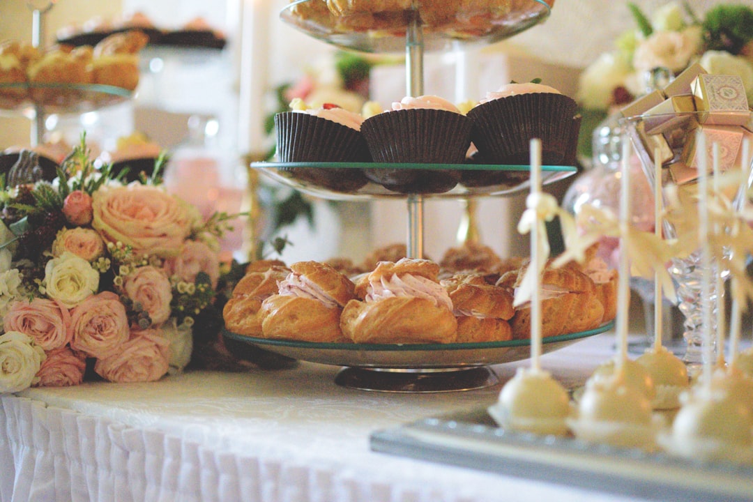 A beautifully arranged dessert table featuring an assortment of pastries, cakes, and sweets, showcasing an elegant and professional presentation.