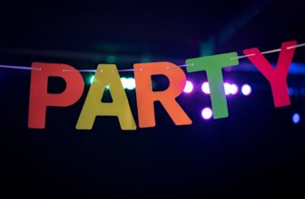 A collection of colorful party supplies including tableware, decorations, and outdoor seating arranged for a festive gathering.