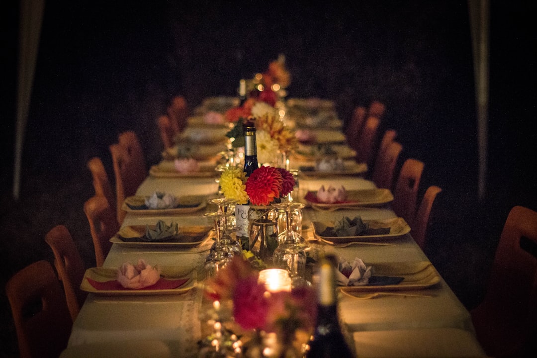 A beautifully arranged dinner table with warm lighting, candles, and inviting decor, perfect for a cozy gathering at home.