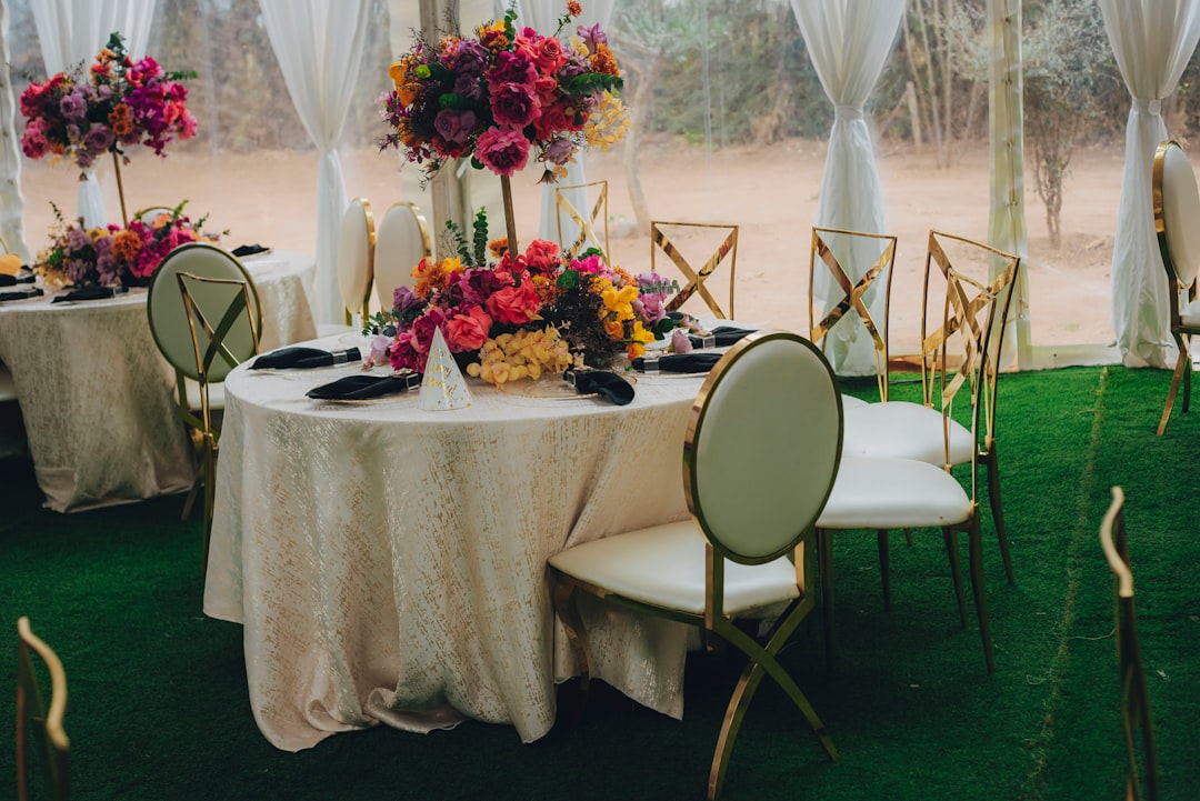 A beautifully arranged table setting with vibrant colors, decorations, and lighting for a festive celebration.