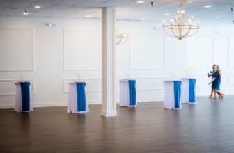 A beautifully decorated room set up for an event, featuring elegant lighting, stylish furniture, and decorative elements that create a festive atmosphere.