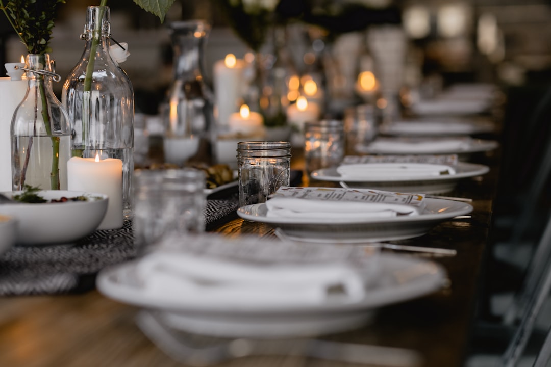 A beautifully arranged table setting with elegant tableware, including plates, cutlery, and glasses, suitable for a themed occasion.